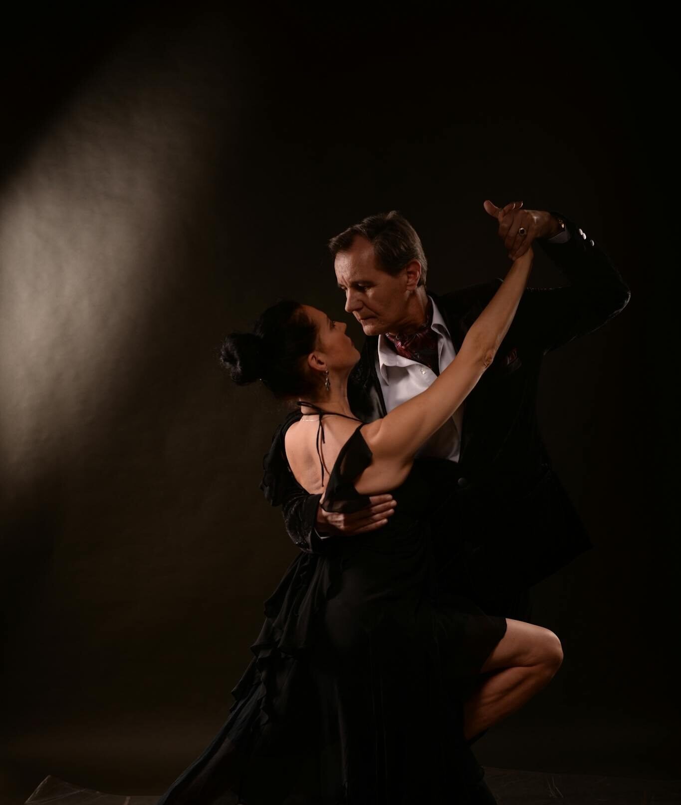 Dynamic tango dancers performing an elegant routine on stage, capturing passion and movement.